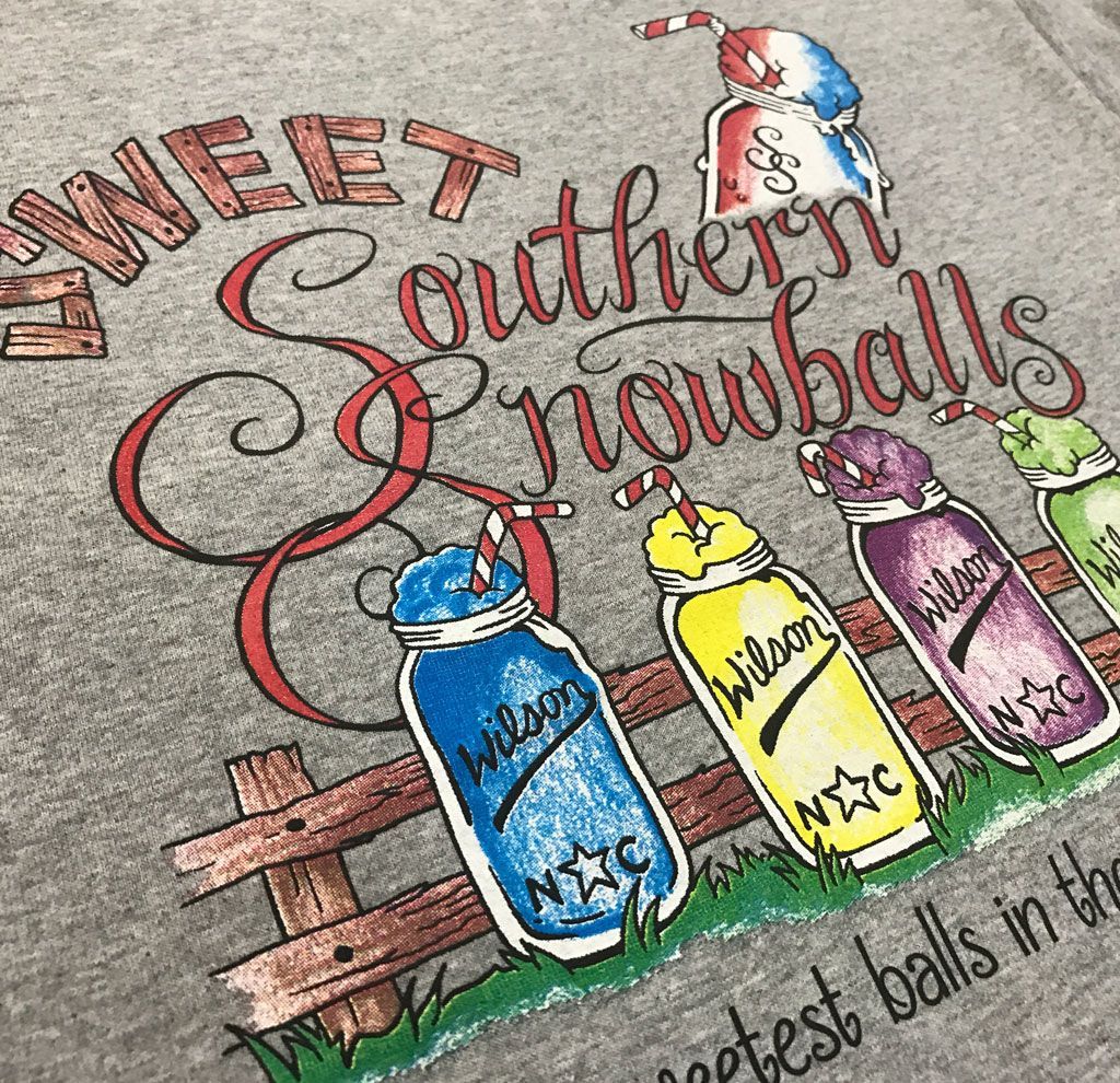 A gray t-shirt with a design featuring colorful mason jar snowballs, a wooden fence, and the text 