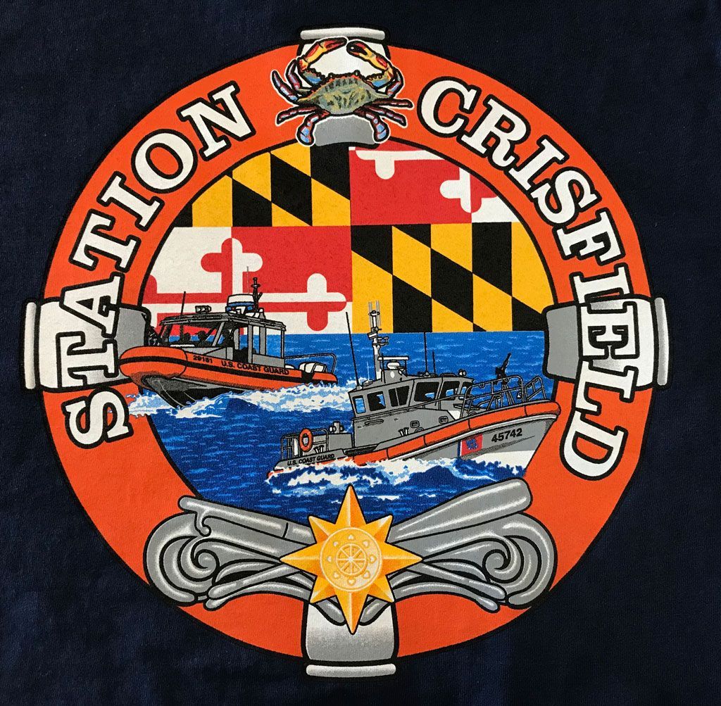 A circular Coast Guard station patch featuring the Maryland flag, two response boats, a blue crab, and a golden star emblem.
