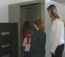 Family getting inside the tornado shelter