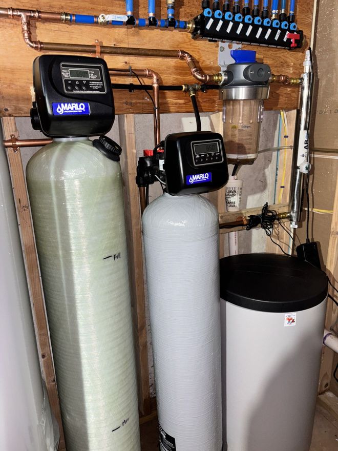 Water filter system with toolbox and tools in a cabinet.