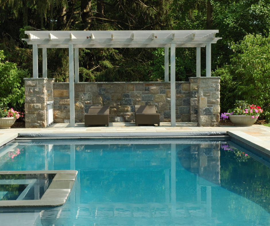 A large swimming pool with a pergola over it