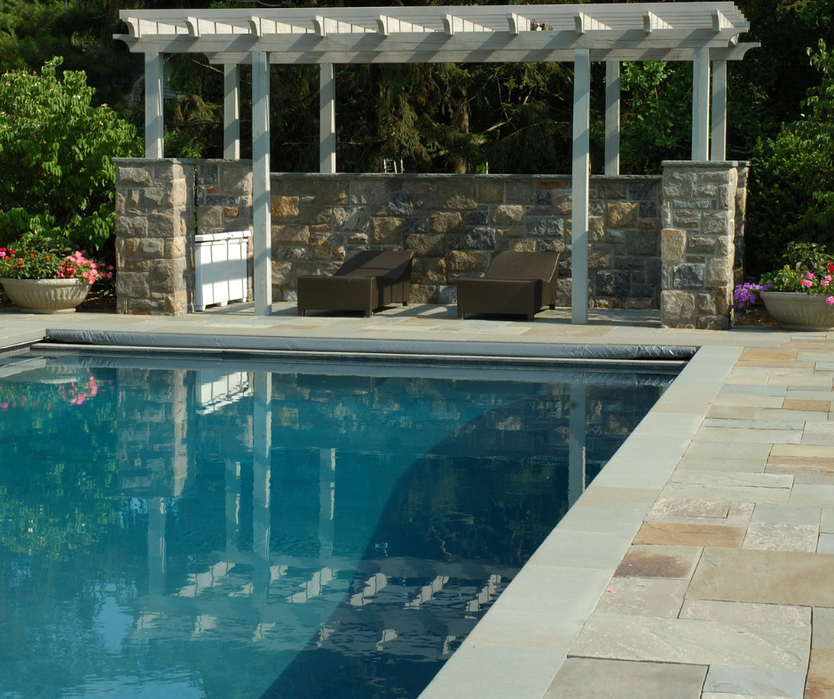 A large swimming pool with a pergola over it