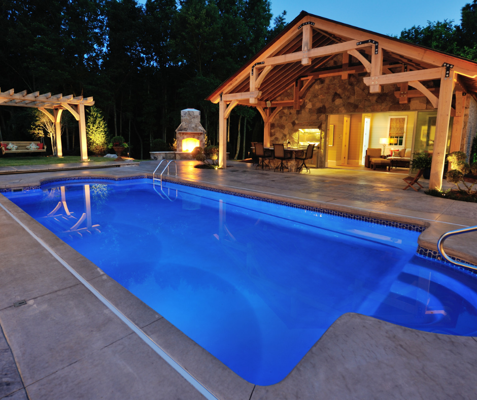 A large swimming pool is lit up at night