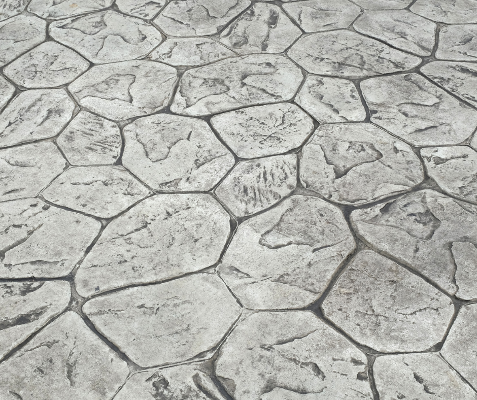 A black and white photo of a concrete floor with a geometric pattern
