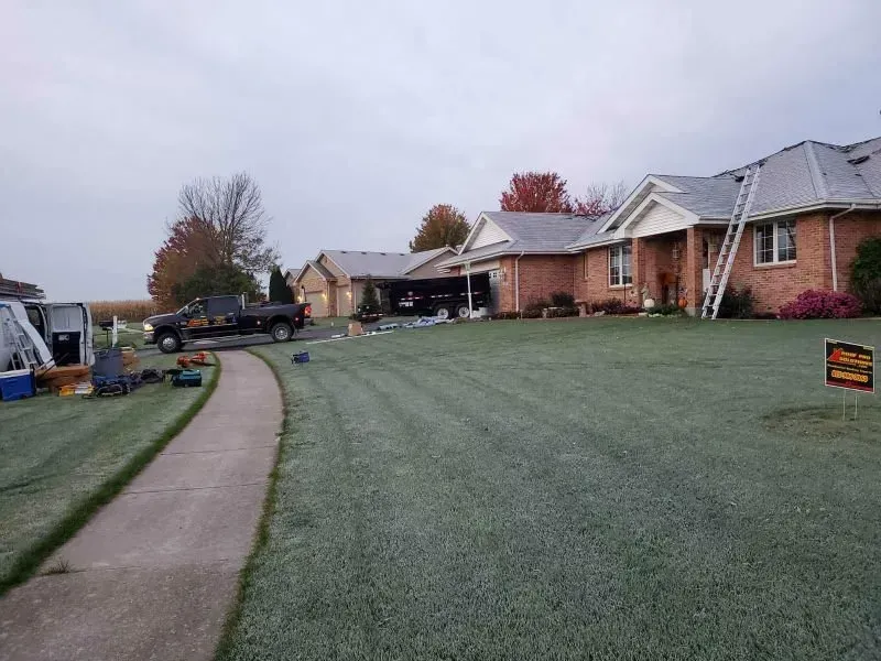 Curved sidewalk beside frosted lawns and brick houses in a suburban neighborhood.