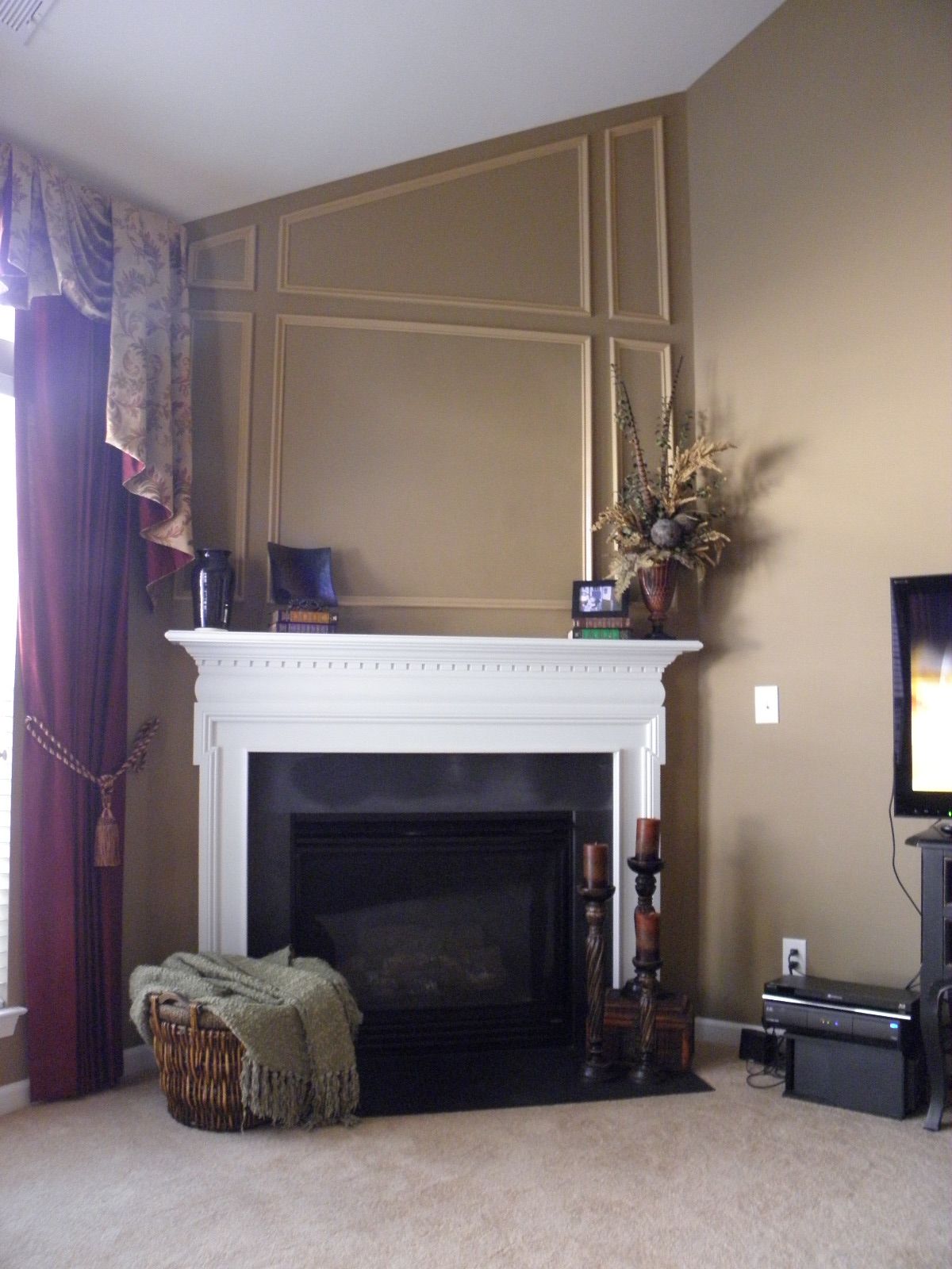 A living room with a fireplace and a television