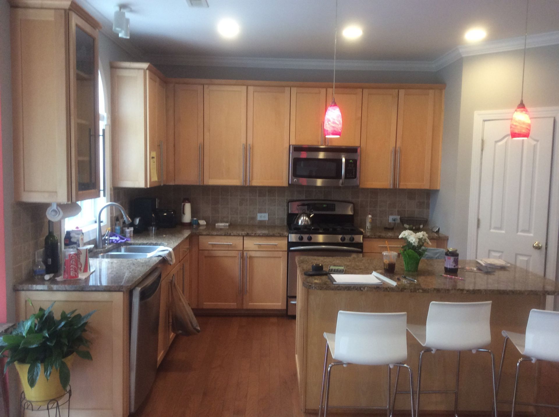 A kitchen with stainless steel appliances and wooden cabinets