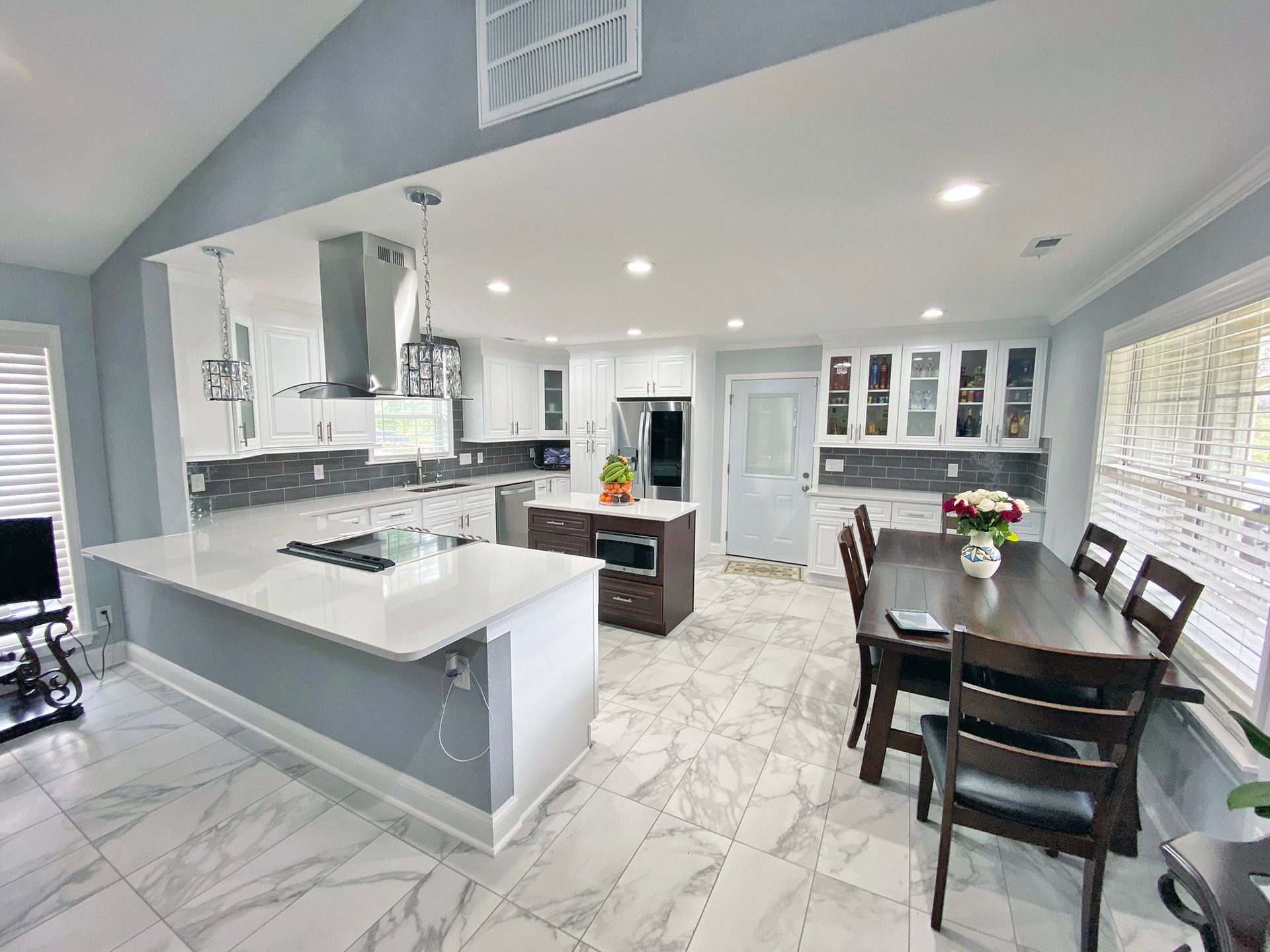 A kitchen and dining room in a house with a table and chairs.