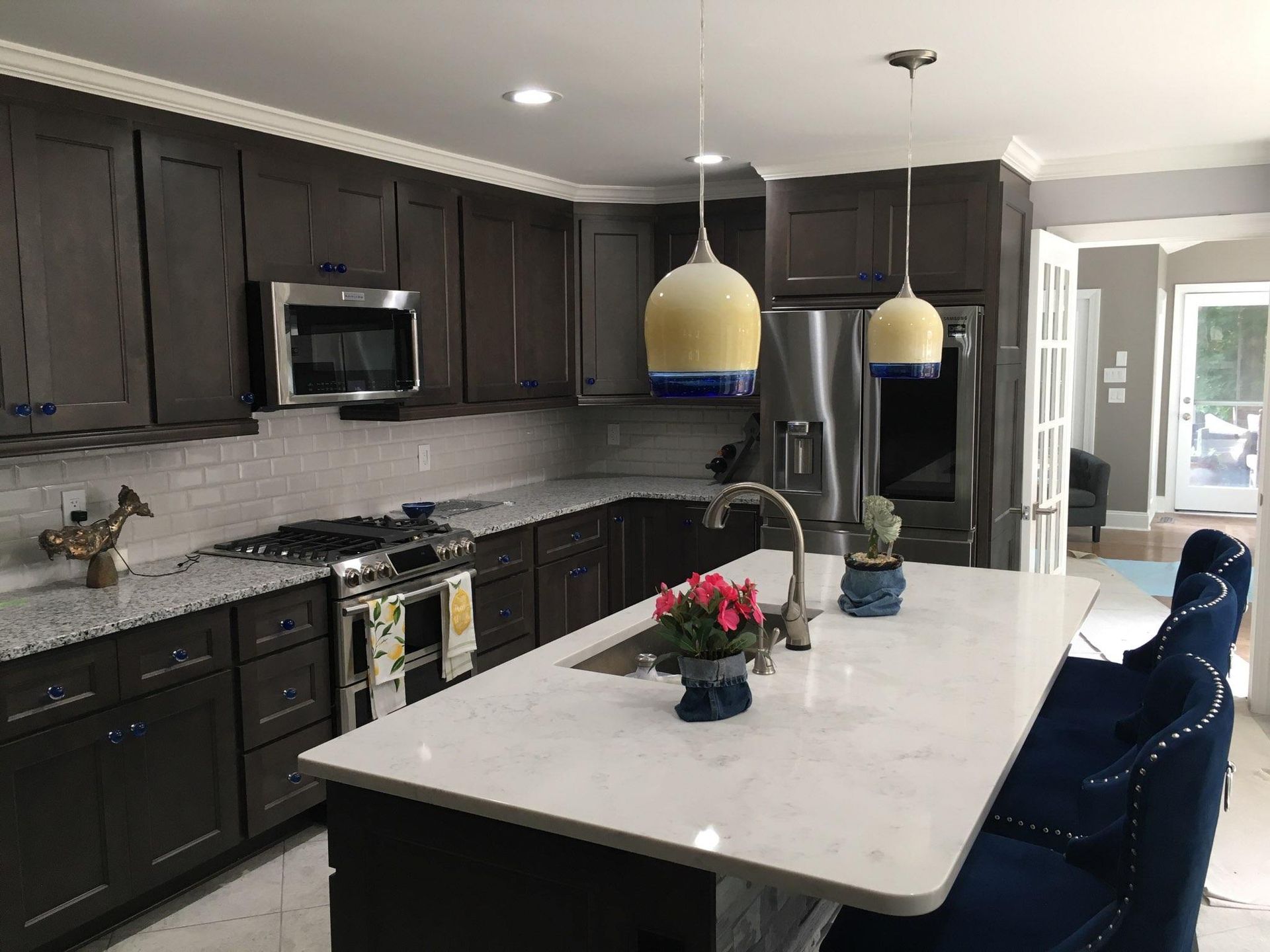 A kitchen with a large island and stainless steel appliances