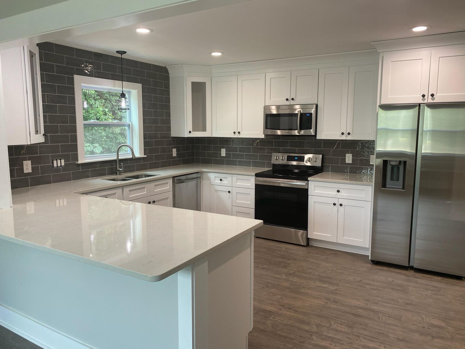 A kitchen with white cabinets and stainless steel appliances.