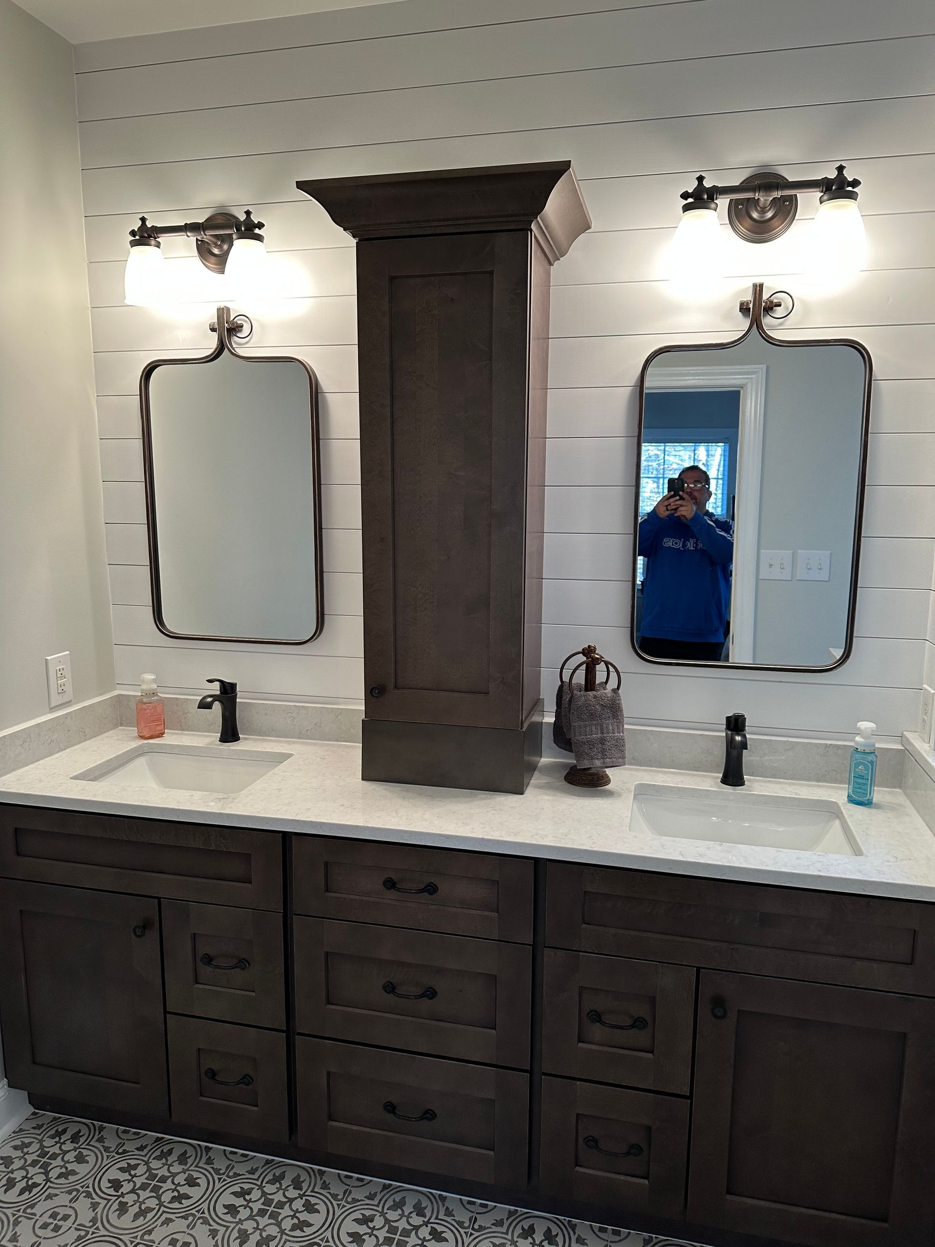 A bathroom with two sinks and two mirrors.
