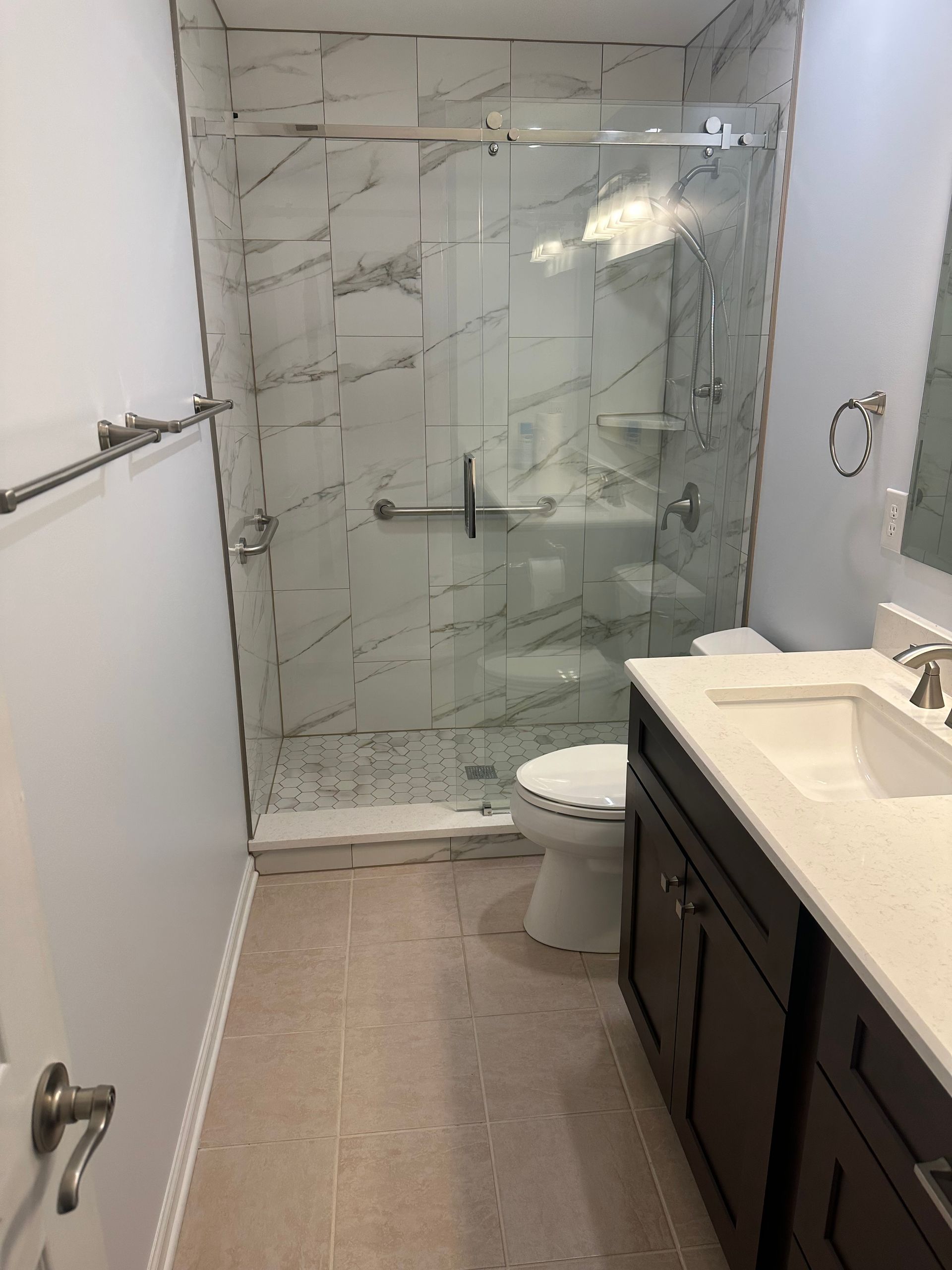 A bathroom with a toilet , sink , and shower.