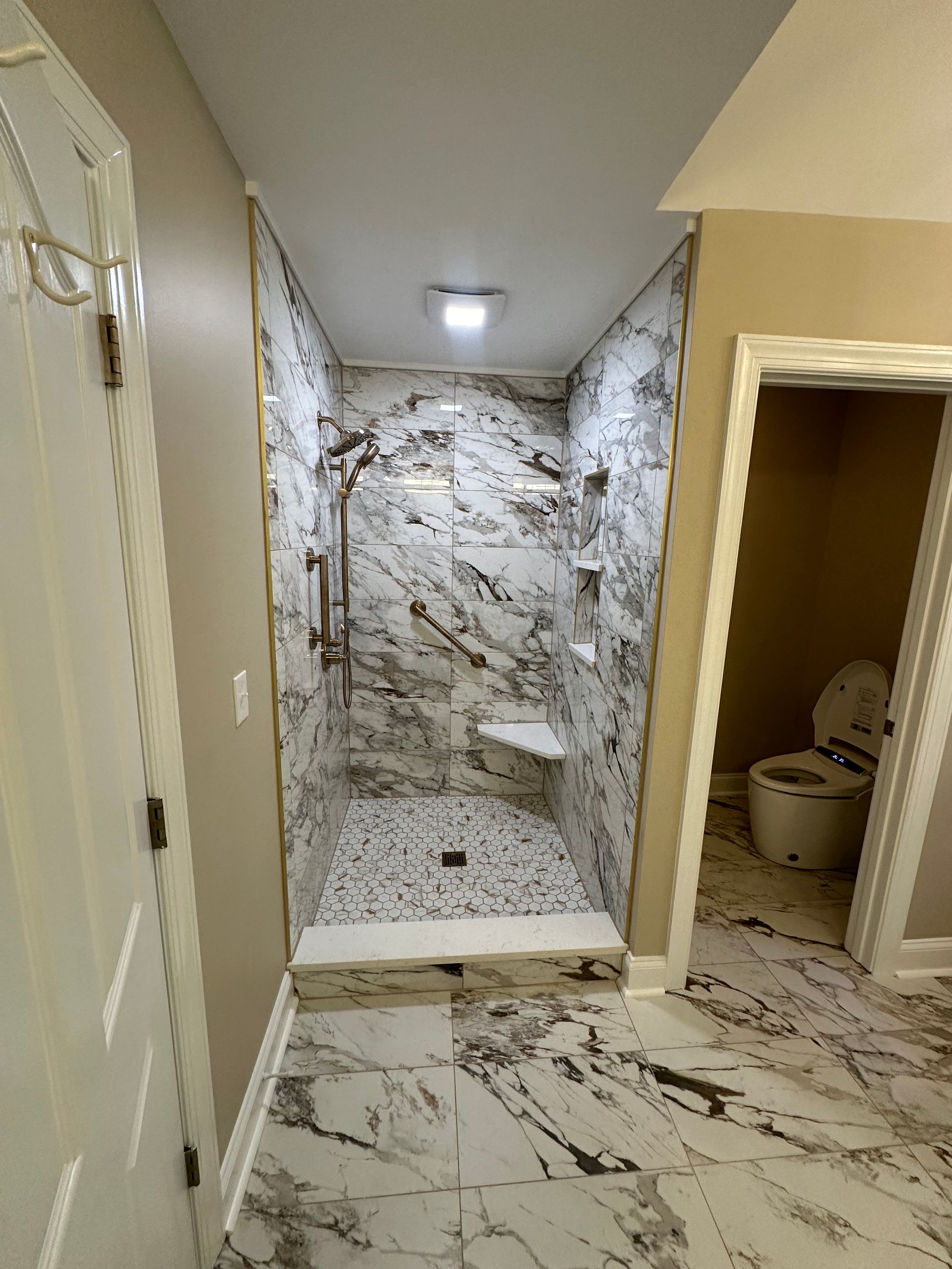 A bathroom with a walk in shower and a toilet.