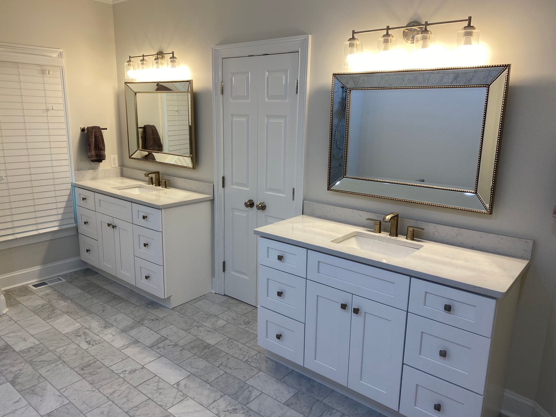 A bathroom with two sinks and two mirrors.
