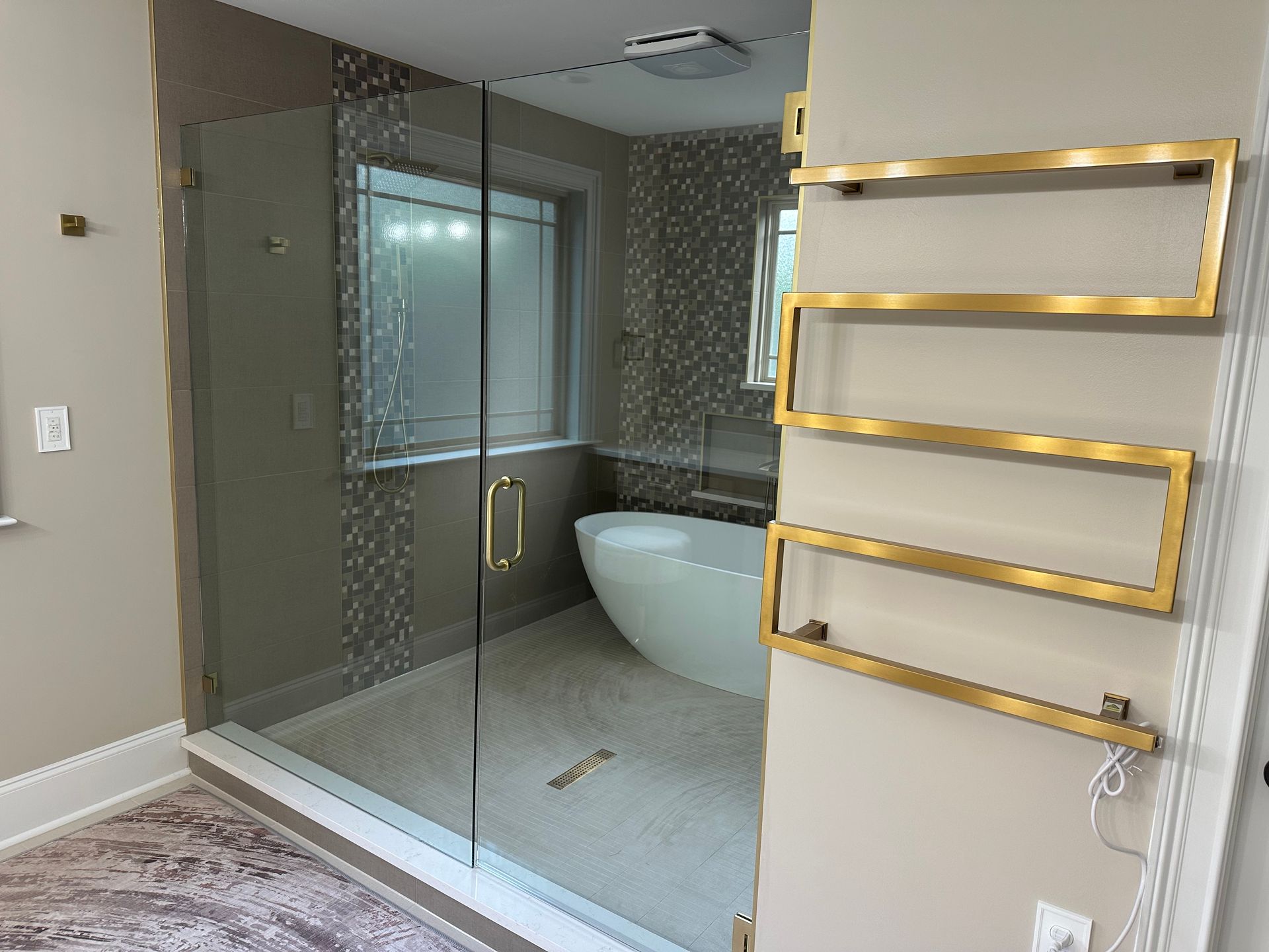 A bathroom with a bathtub , shower , and towel rack.