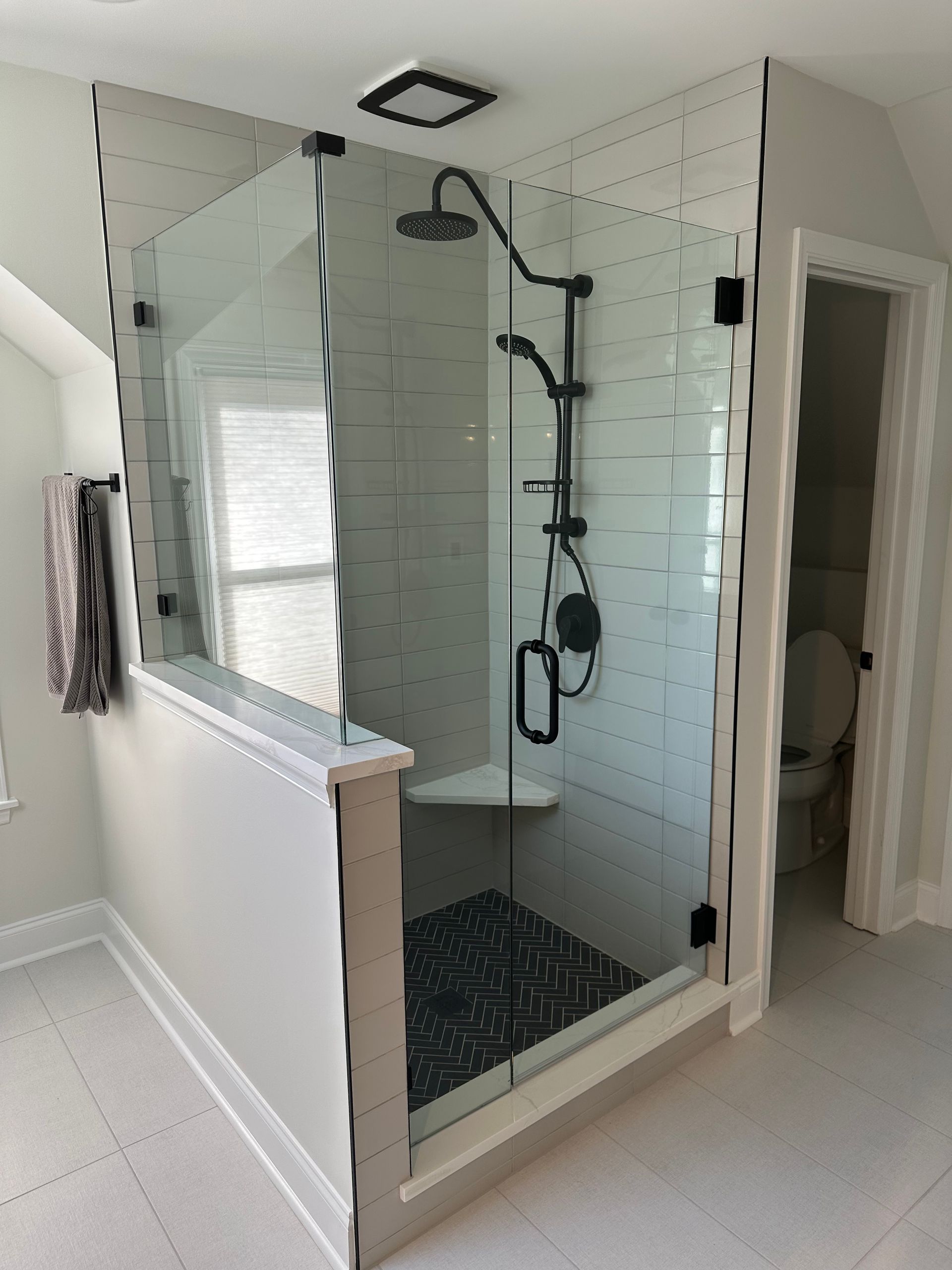 A bathroom with a walk in shower and a toilet