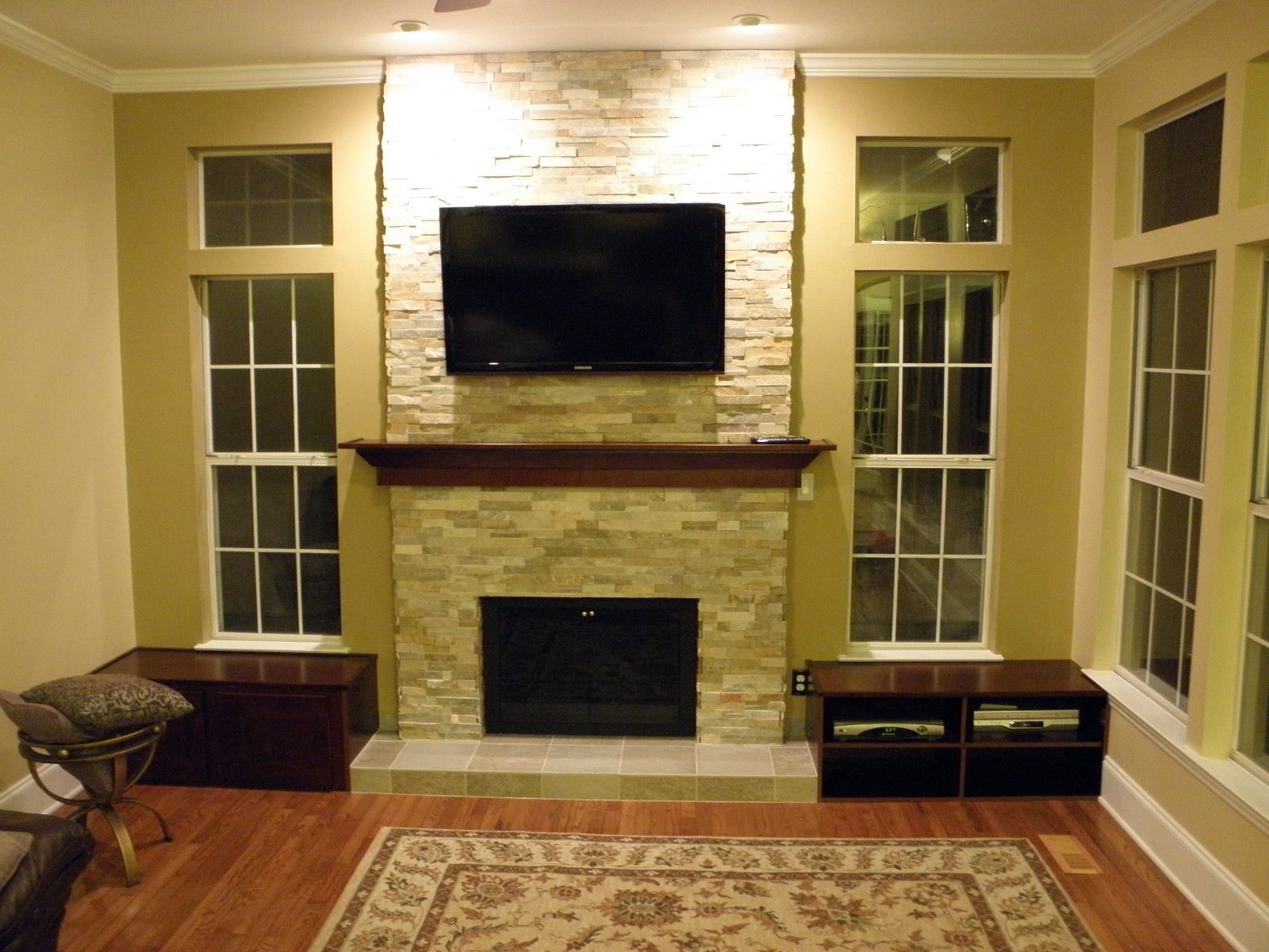 A living room with a fireplace and a flat screen tv