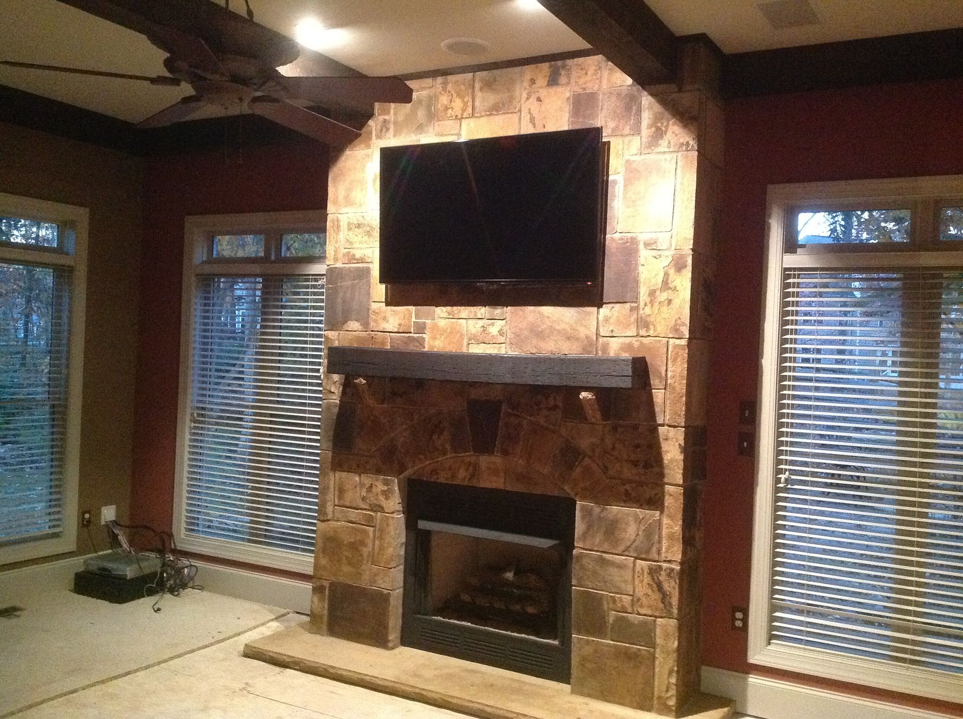A fireplace with a flat screen tv mounted above it
