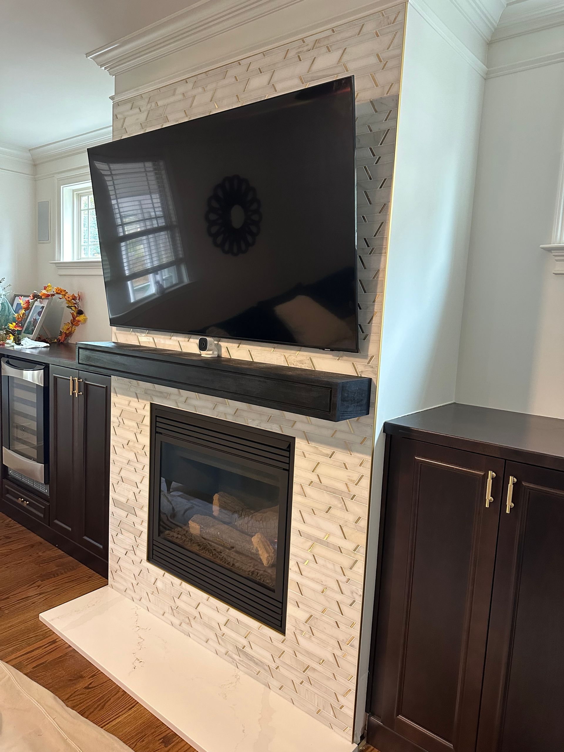 A living room with a fireplace and a flat screen tv.