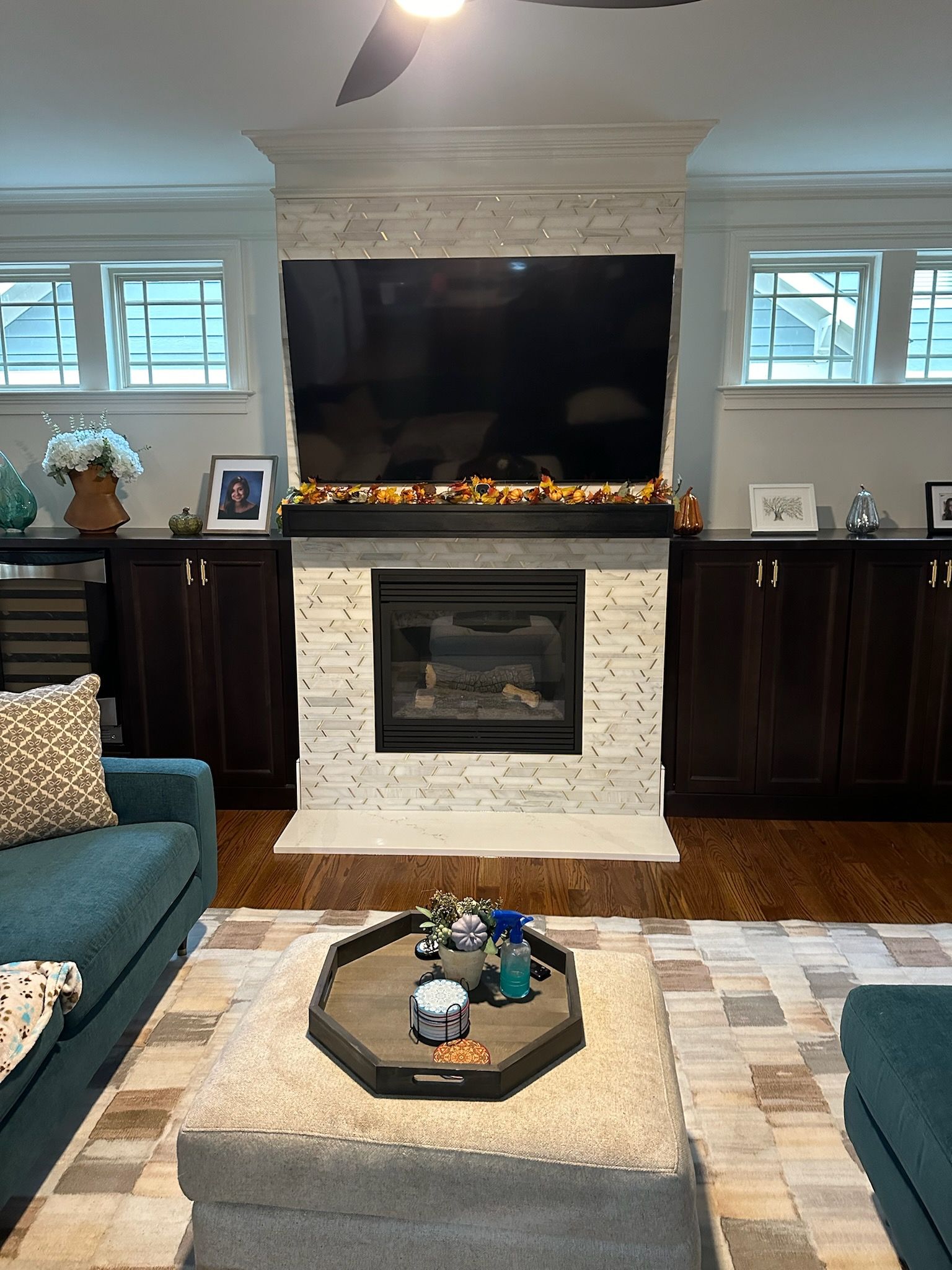 A living room with a fireplace and a flat screen tv