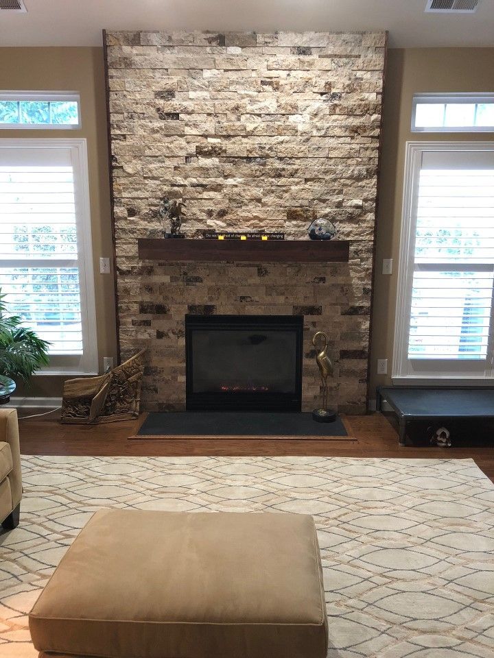 There is a fireplace in the middle of the living room.
