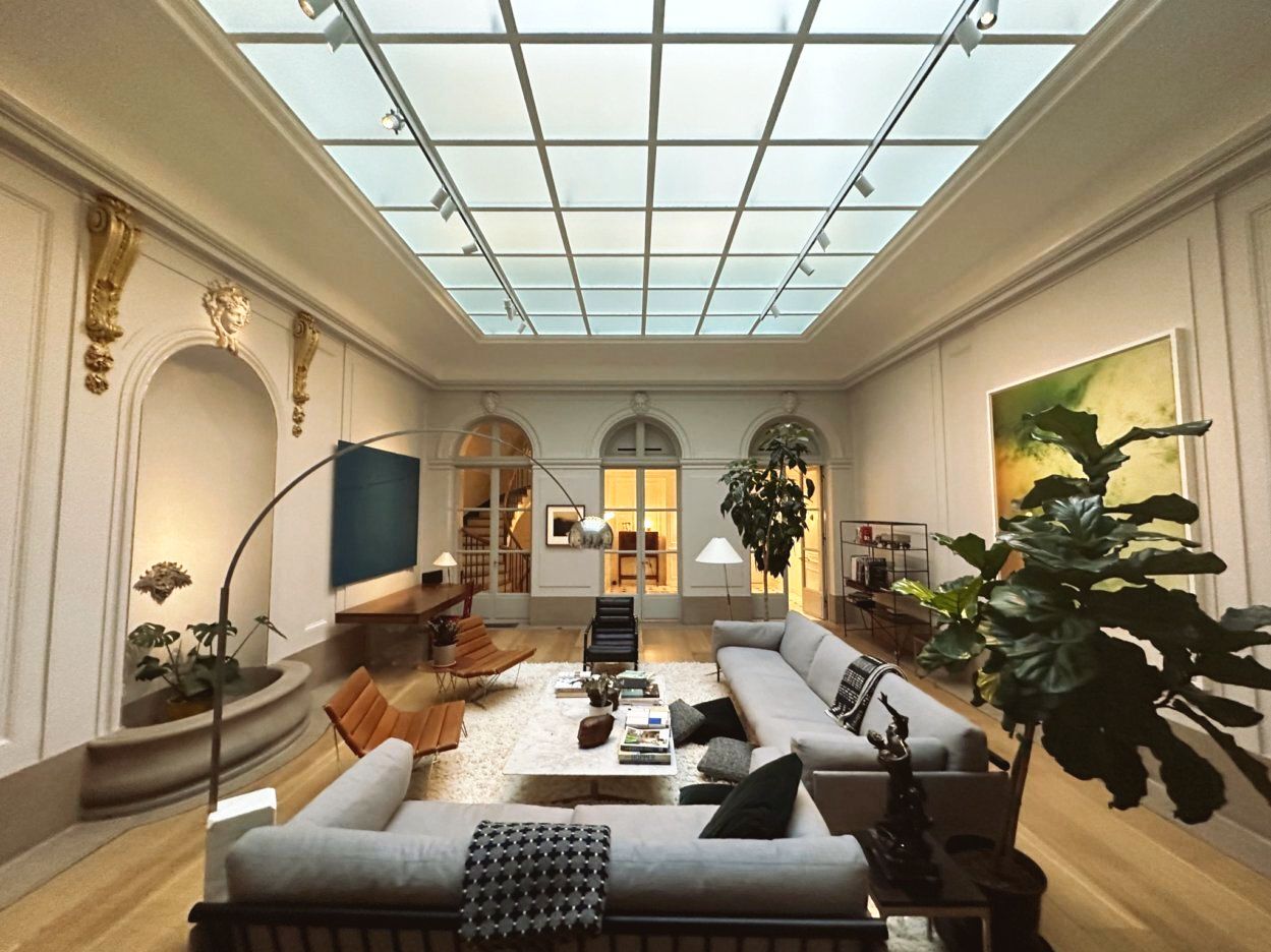 A living room with a glass ceiling and a couch