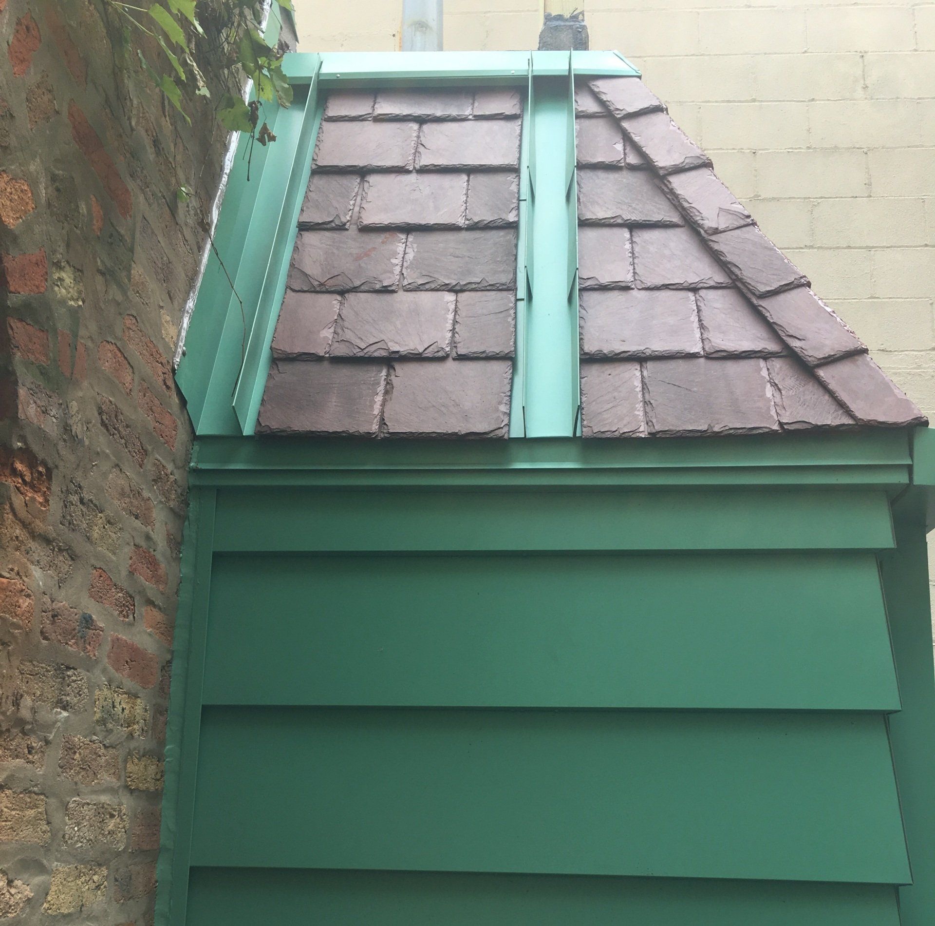 New slate roof, metal siding, and gutters