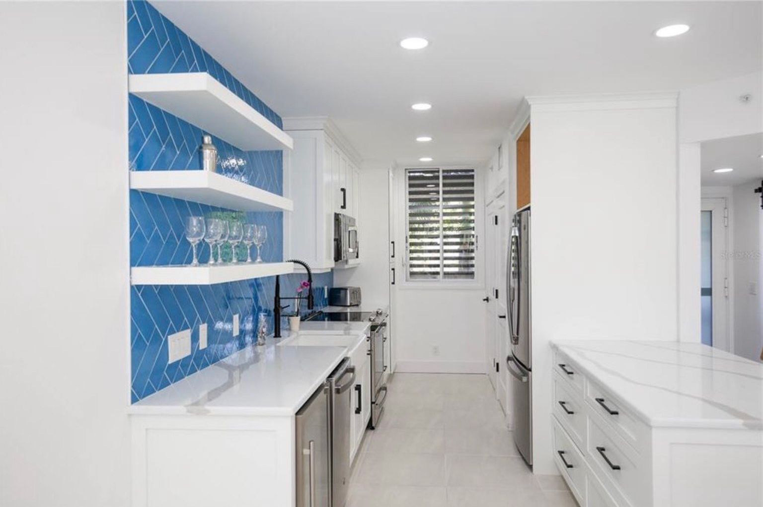 White kitchen with blue wall tiles