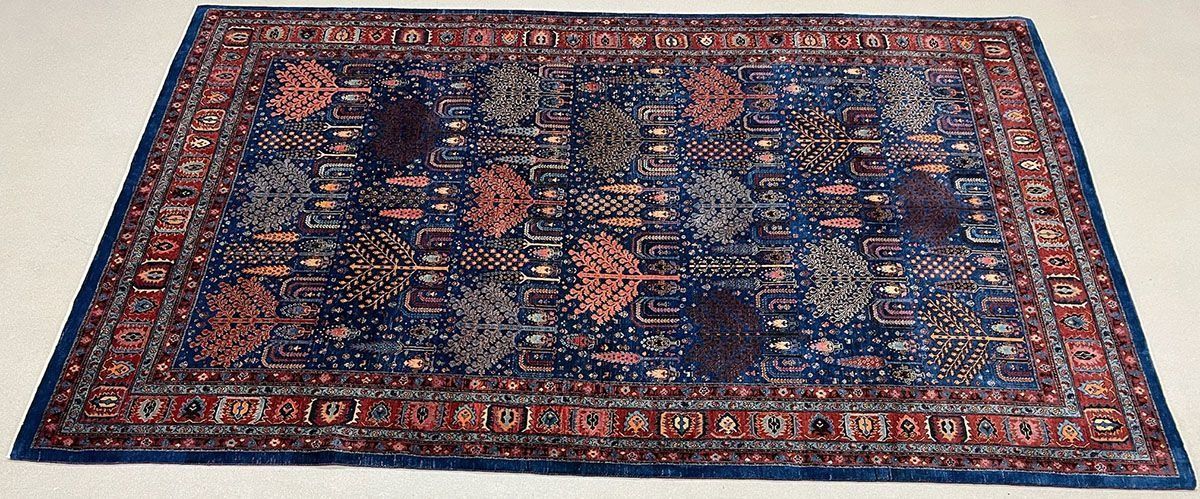 Blue and red patterned rug on a white surface.