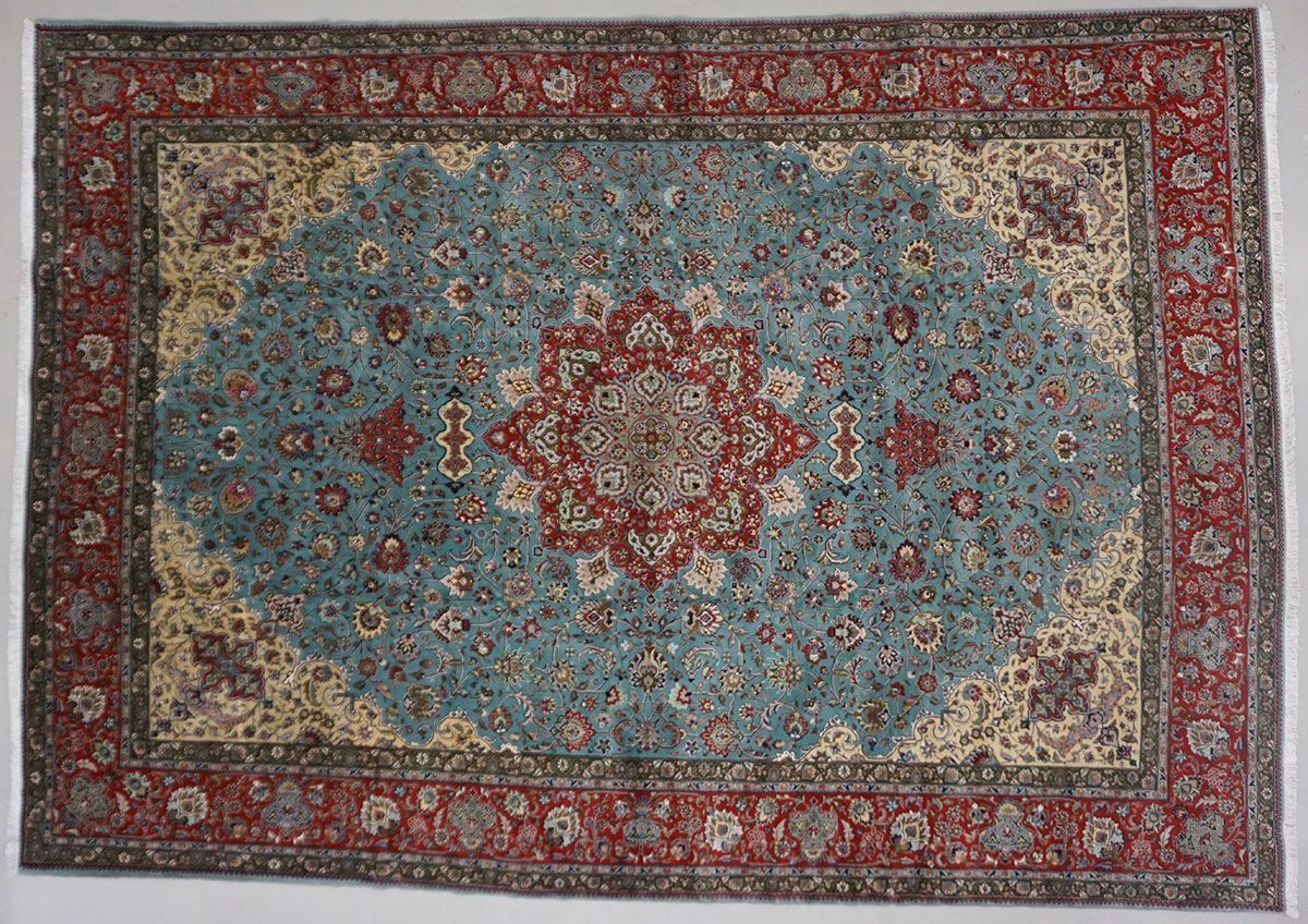 Blue and red Persian rug with a central medallion pattern and ornate border.