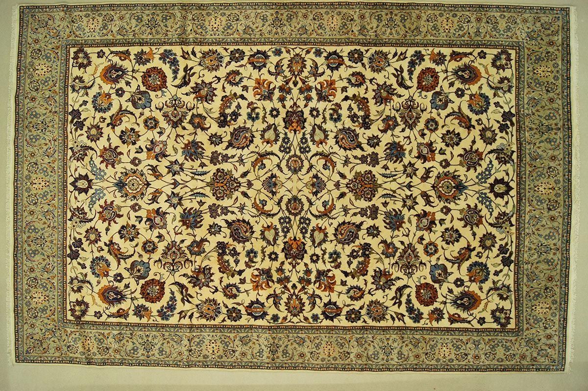 Cream-colored rectangular rug with floral pattern and border.