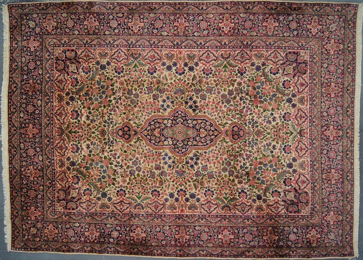 Oriental rug with floral design in shades of red, green, and navy.