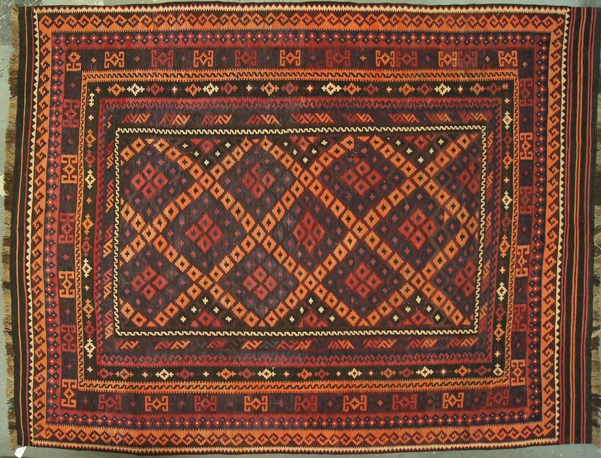 Brown and orange patterned rug with a diamond and geometric design.