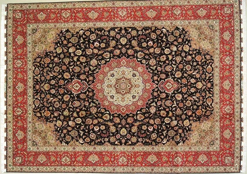 Intricately patterned Persian rug, dark center with floral motifs, red border.