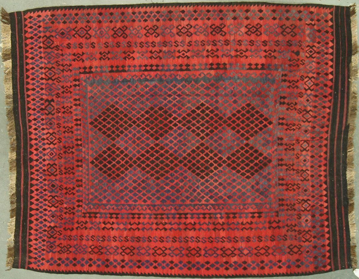 Red and brown woven rug with geometric patterns.