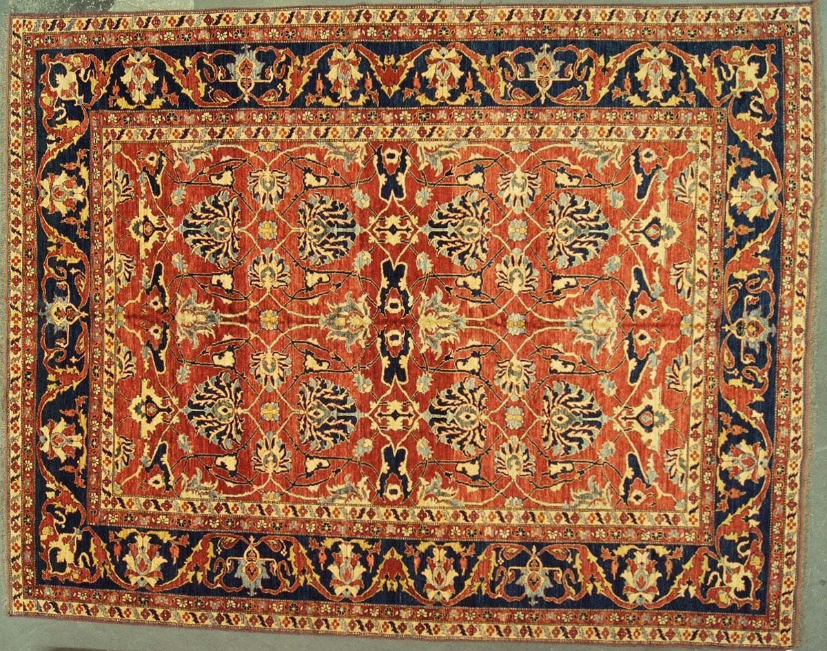Red and blue Persian rug with floral motifs and border.