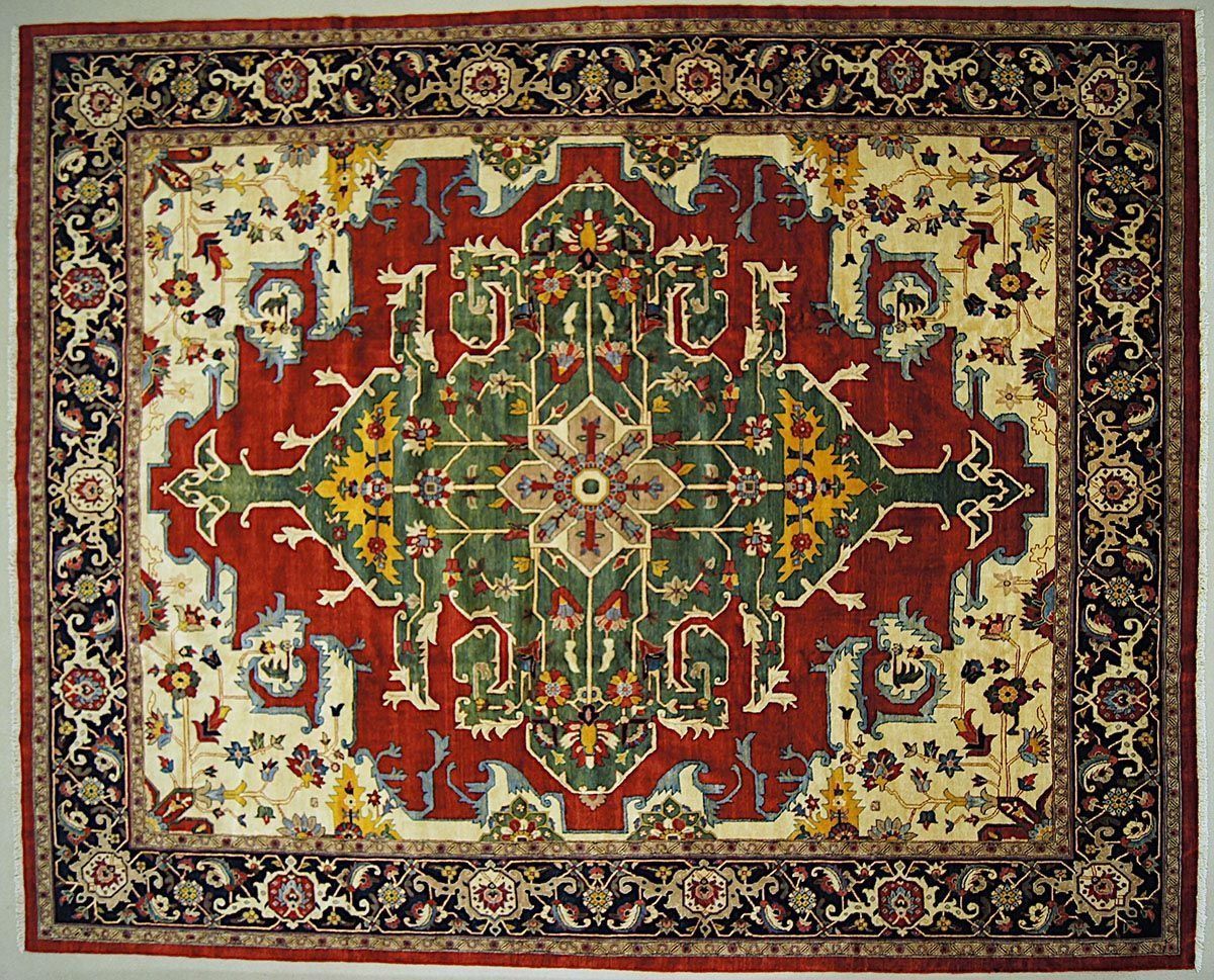 Oriental rug with cream, red, and green floral pattern and black border.