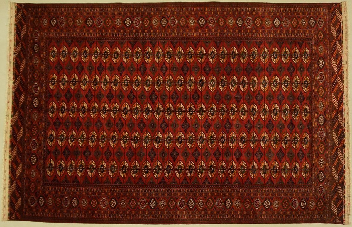 Red and gold Oriental rug with diamond-shaped central pattern and patterned border.