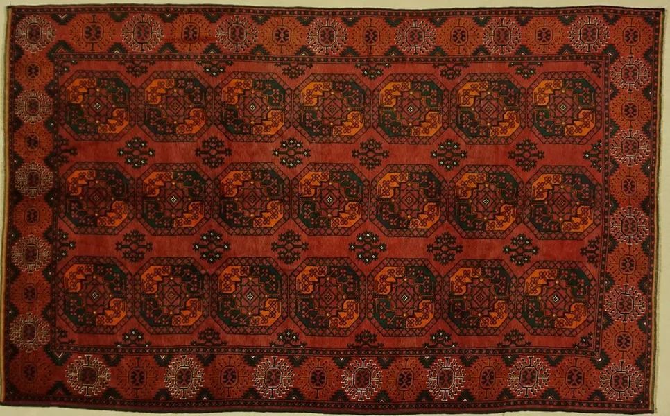 Red and brown oriental rug with repeating geometric patterns.