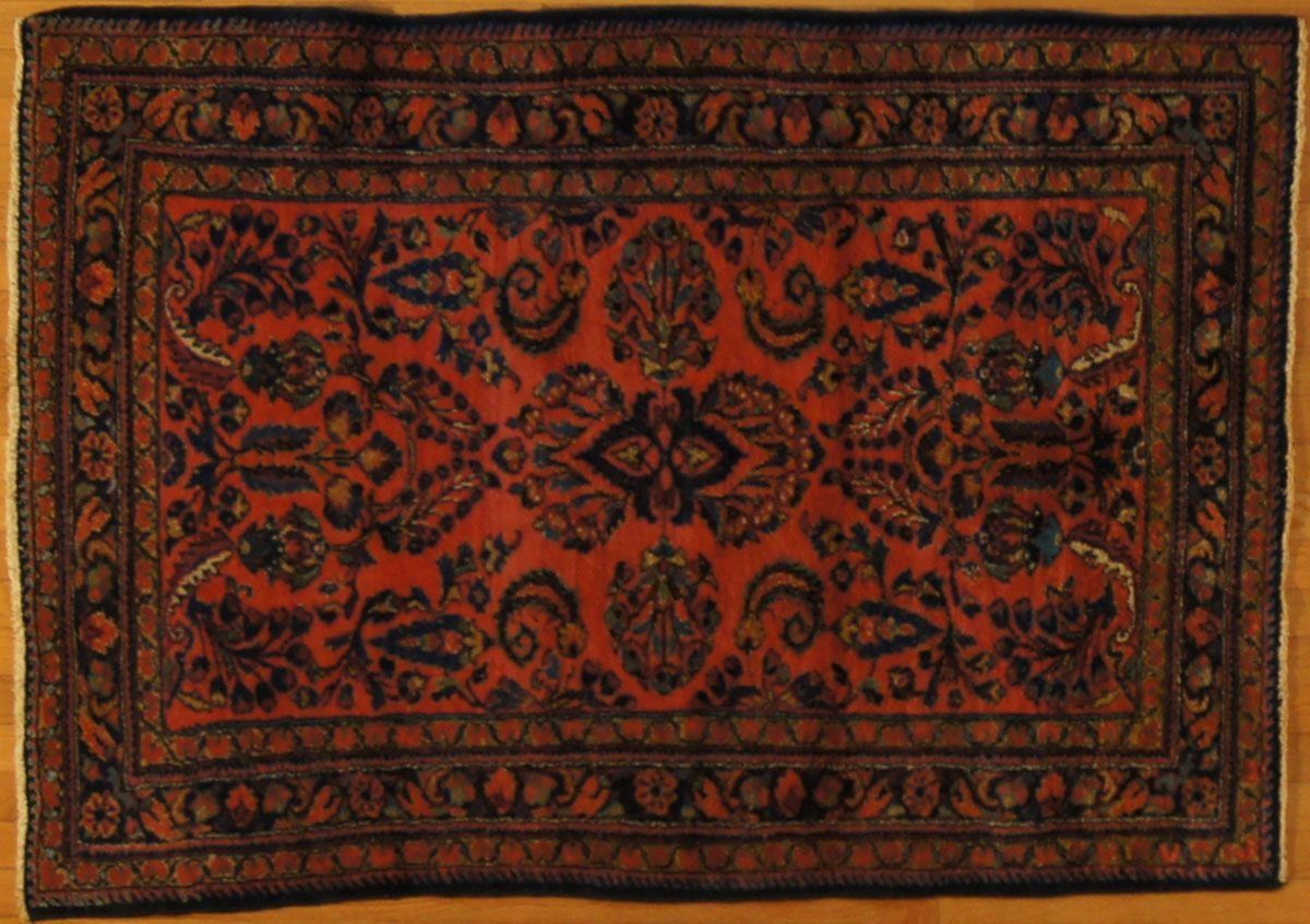 Red and navy Persian rug with ornate floral and paisley patterns.