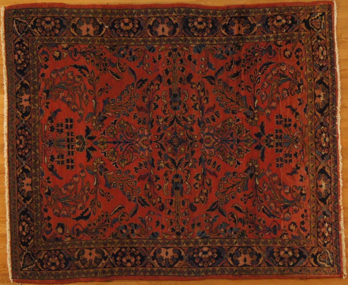 Red and navy oriental rug with floral and geometric patterns.