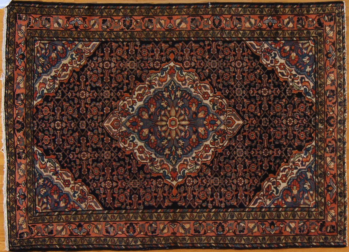 Dark blue Persian rug with a central medallion and ornate border.