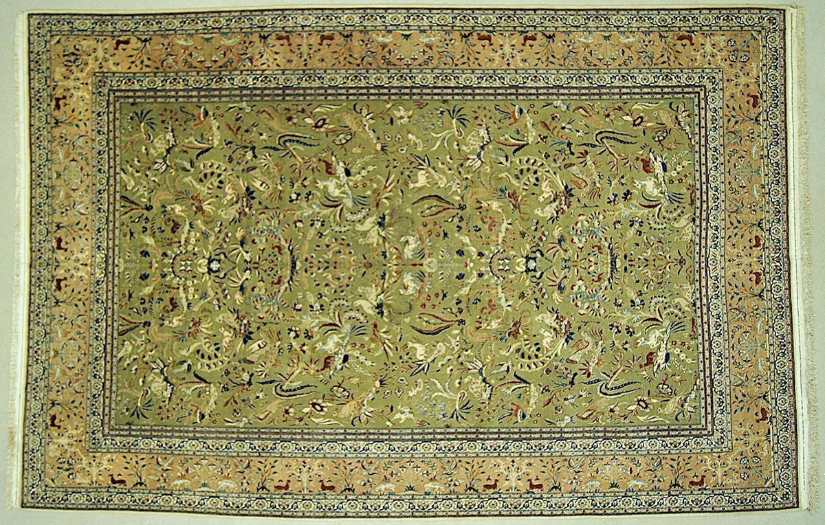 Green and beige Persian rug with floral and animal motifs, framed by patterned borders.