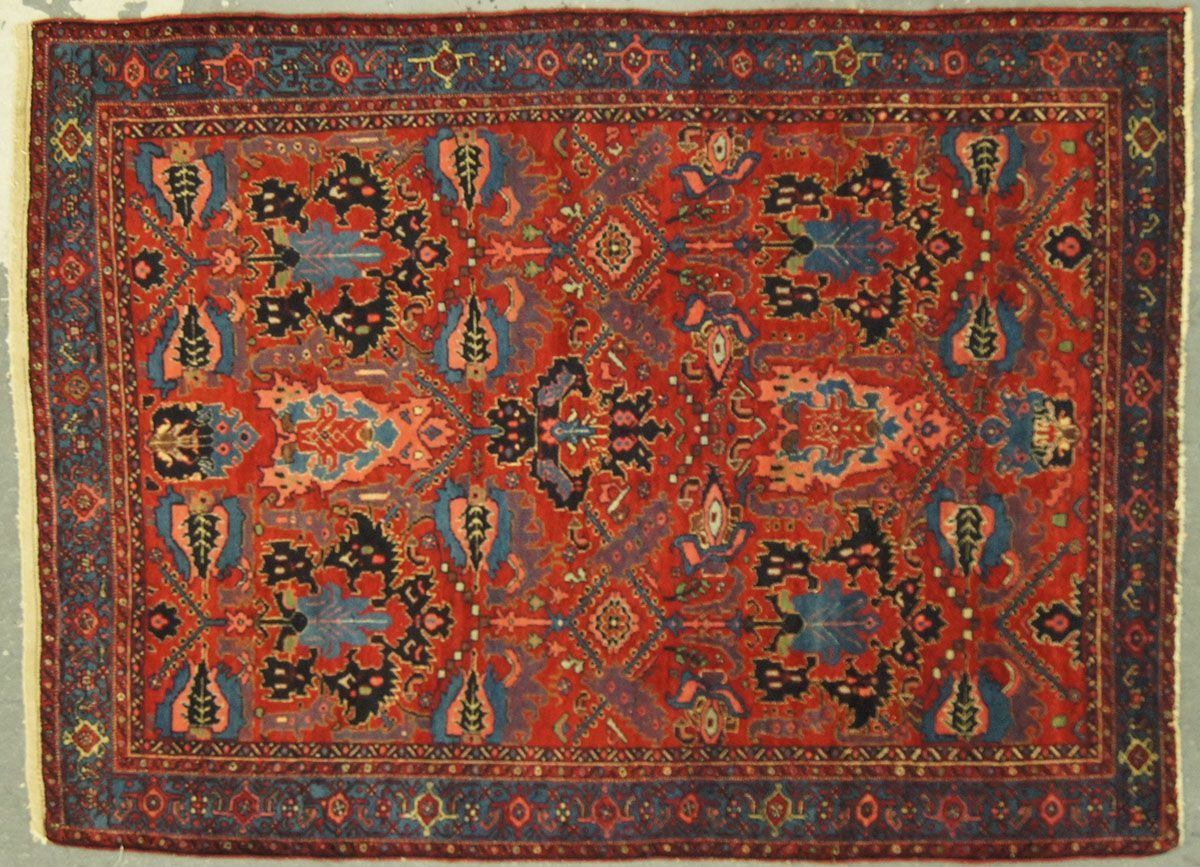 Red, blue, and black oriental rug with floral and geometric patterns.
