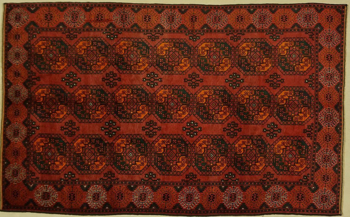 Red, rectangular Oriental rug with repeated geometric patterns in dark brown and orange.