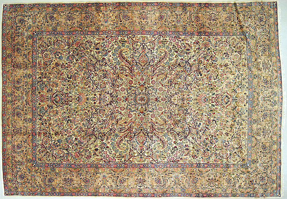 Oriental rug with intricate floral patterns in beige, blue, and red tones.