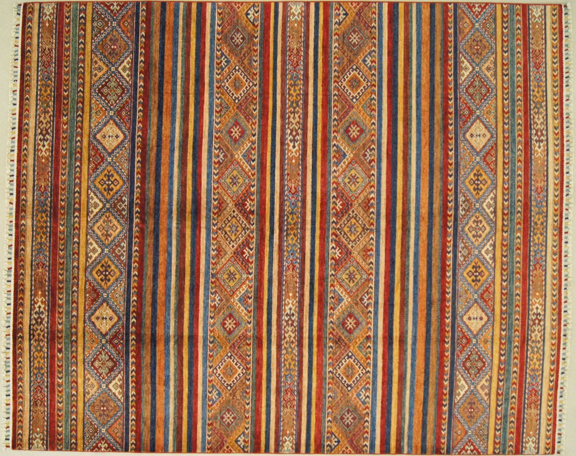 Colorful patterned rug with vertical stripes and geometric designs.