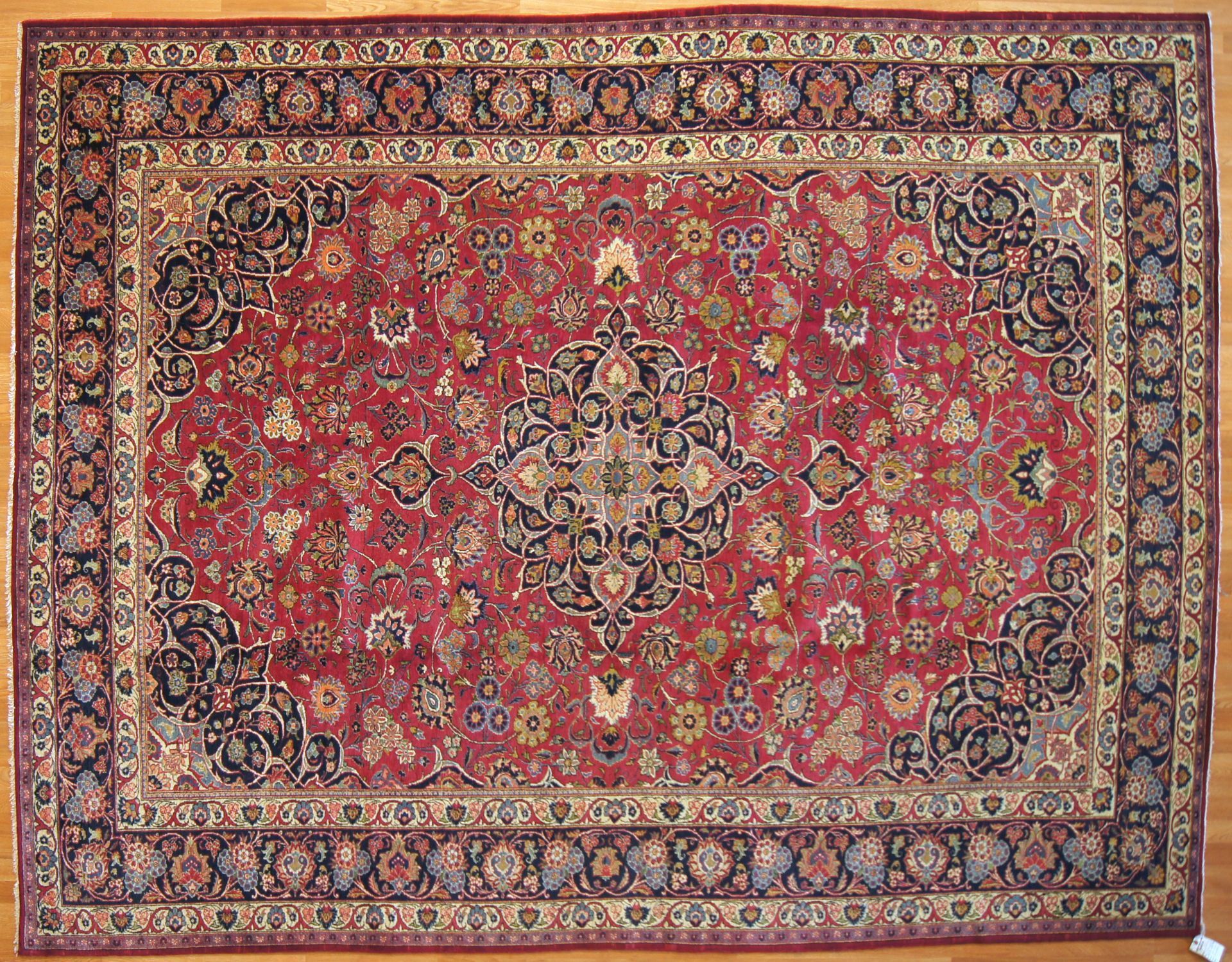 Red Persian rug with a central medallion and ornate border