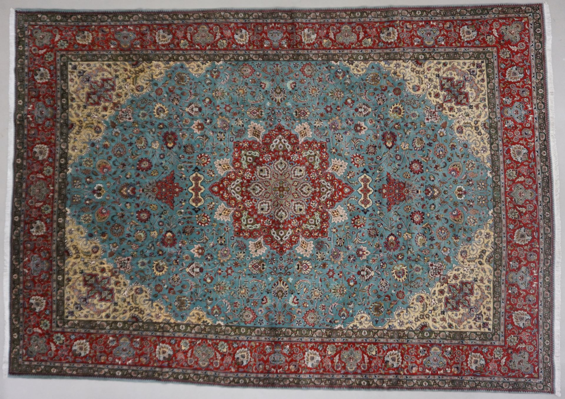 Blue and red ornate oriental rug with floral and medallion patterns.