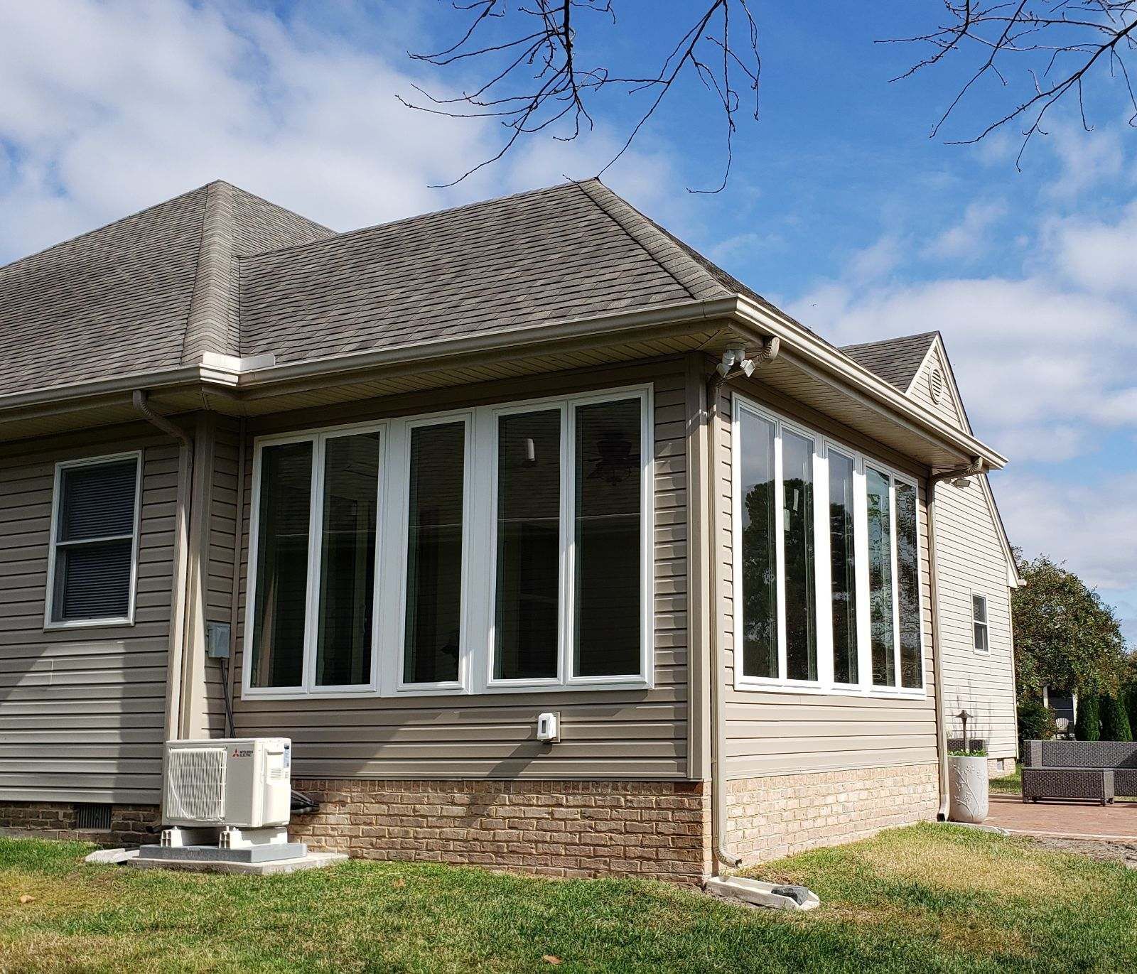 A house with a lot of windows on a sunny day.